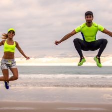 Young couple runners training on the beach