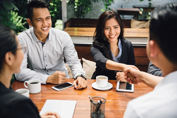 Manager coaching two seasonal servers at a side station — Sales, Management & Leadership Training in Dunedin